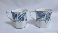 Front view of both mugs showing strawberry design