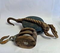 both pulleys side by side showing size comparison, hooks, rope