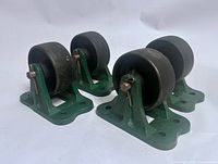 Four green-bracket Fairbanks cast iron casters angled side view