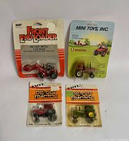 Front view of all four sealed tractors on cards
