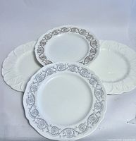 Three of the four plates showing two patterned Spode and one plain white Coalport plate