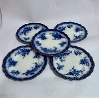 Five flow blue plates front view