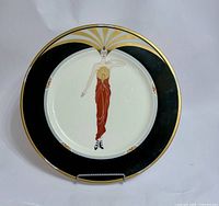 Front view of Erte Le Soleil Ebony bone china plate on stand