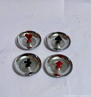Overview of all four chrome ashtrays showing suit finials