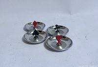 Four chrome ashtrays with card suit finials top view