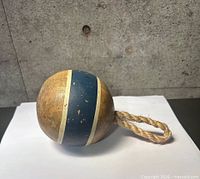 Wooden float buoy showing size, paint details and rope