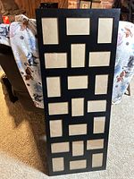 Full view of black collage frame showing 21 openings