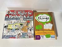 Front covers of both board game boxes side by side