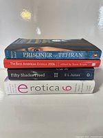 Stack of four books showing titles and authors