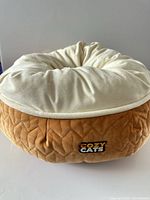 Front view showing tan quilted exterior and Cozy Cats logo