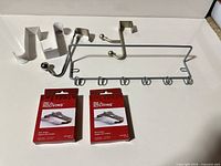 All hooks and boxed brick hangers laid out on flat surface