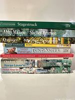 Stack of all eight books showing titles on spines