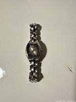 Front view showing dial, case shape and bracelet