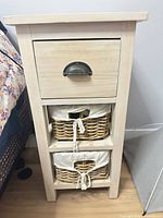 Front view of nightstand showing drawer and two baskets