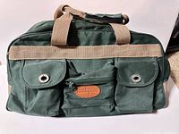 Front view showing pockets, straps, logo