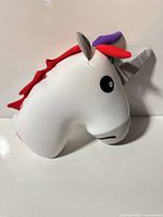 Unicorn head plush side of reversible travel pillow