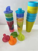 Group of tumblers stacked with lids shown separately