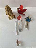 Group shot of squirrel figurine, cardinal wind chime and angel ornament
