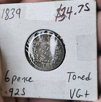 Coin in 2×2 cardboard flip, reverse side visible with date and value