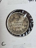 Reverse of 1907 Canadian 10 cent coin showing crown and maple wreath