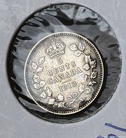 Reverse of 1913 Canada 5 cents coin in holder