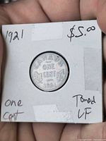 Coin in flip showing date, denomination and holder notes