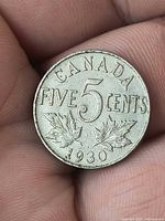 Reverse of 1930 Canadian five-cent coin showing maple leaves and date