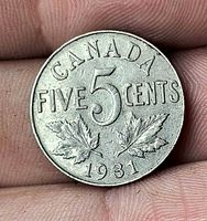 Reverse side showing CANADA FIVE CENTS 1931 and maple leaves