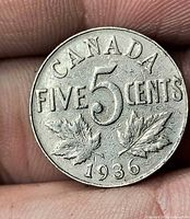Reverse side displaying CANADA, FIVE CENTS, large 5, maple leaves, date 1936