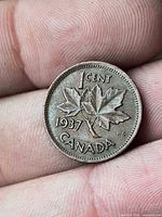 Reverse side showing maple leaves, date and denomination