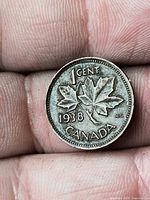 Reverse of 1938 Canada 1-cent coin showing maple leaf design and date