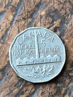 Reverse of 1951 Canada 5-cent coin showing refinery design and dates 1751-1951
