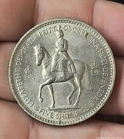 Obverse showing Queen Elizabeth II on horseback, denomination FIVE SHILLINGS