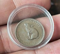 Reverse showing hare design, denomination, dates, protective capsule visible