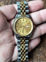 Front view of Bulova two-tone wristwatch on hand