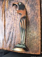 Front view of parrot bottle opener standing upright