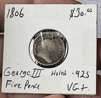 Front of coin in 2x2 flip showing obverse portrait and drilled hole