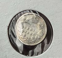 Reverse of 1897 5-cent coin inside flip