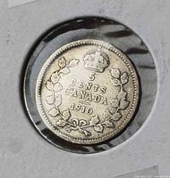 Reverse of 1910 Canada 5 cent coin in flip