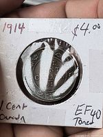 Reverse of 1914 large penny in flip showing ONE CENT CANADA 1914 legend
