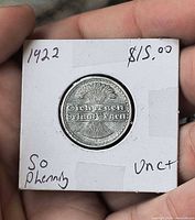 Coin reverse showing rays, oak motif and holder markings