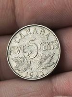 Reverse side showing CANADA FIVE CENTS denomination, two maple leaves, date 1922