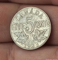 Reverse side showing denomination, maple leaves and year 1923