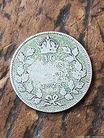 Reverse of 1928 Canada 10 cent coin showing crown, denomination, date, wreath