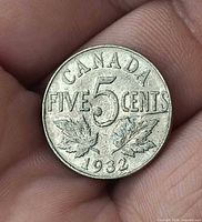 Reverse side showing denomination, maple leaves, and date