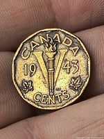 Reverse of 1943 Canadian 5 cent coin showing V victory torch design