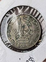 Reverse showing crowned lion, date 1944, legend FID DEF IND IMP ONE SHILLING