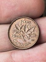 Reverse of 1948 Canadian 1-cent coin showing maple leaf design and date
