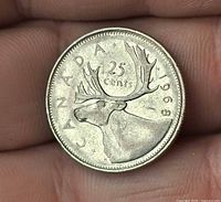 Reverse of 1968 Canadian quarter showing caribou and date