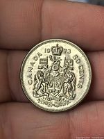 Reverse showing CANADA 1973 50 CENTS and coat of arms design